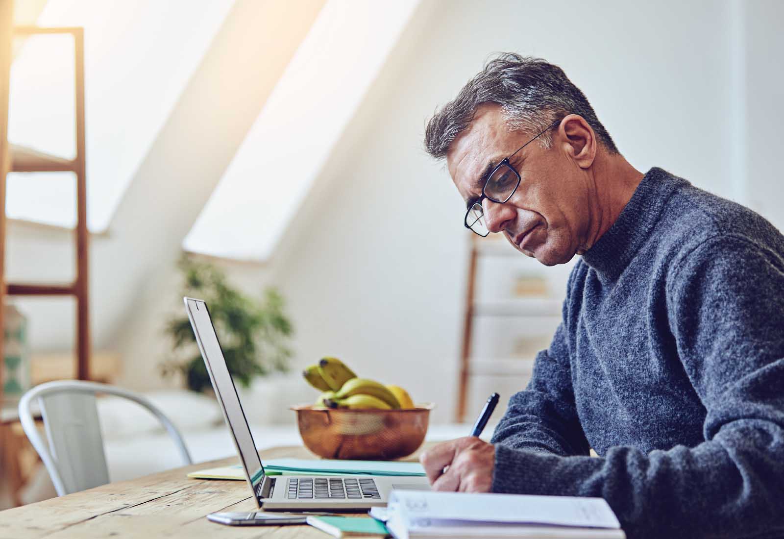 man working at laptop on museum grant application