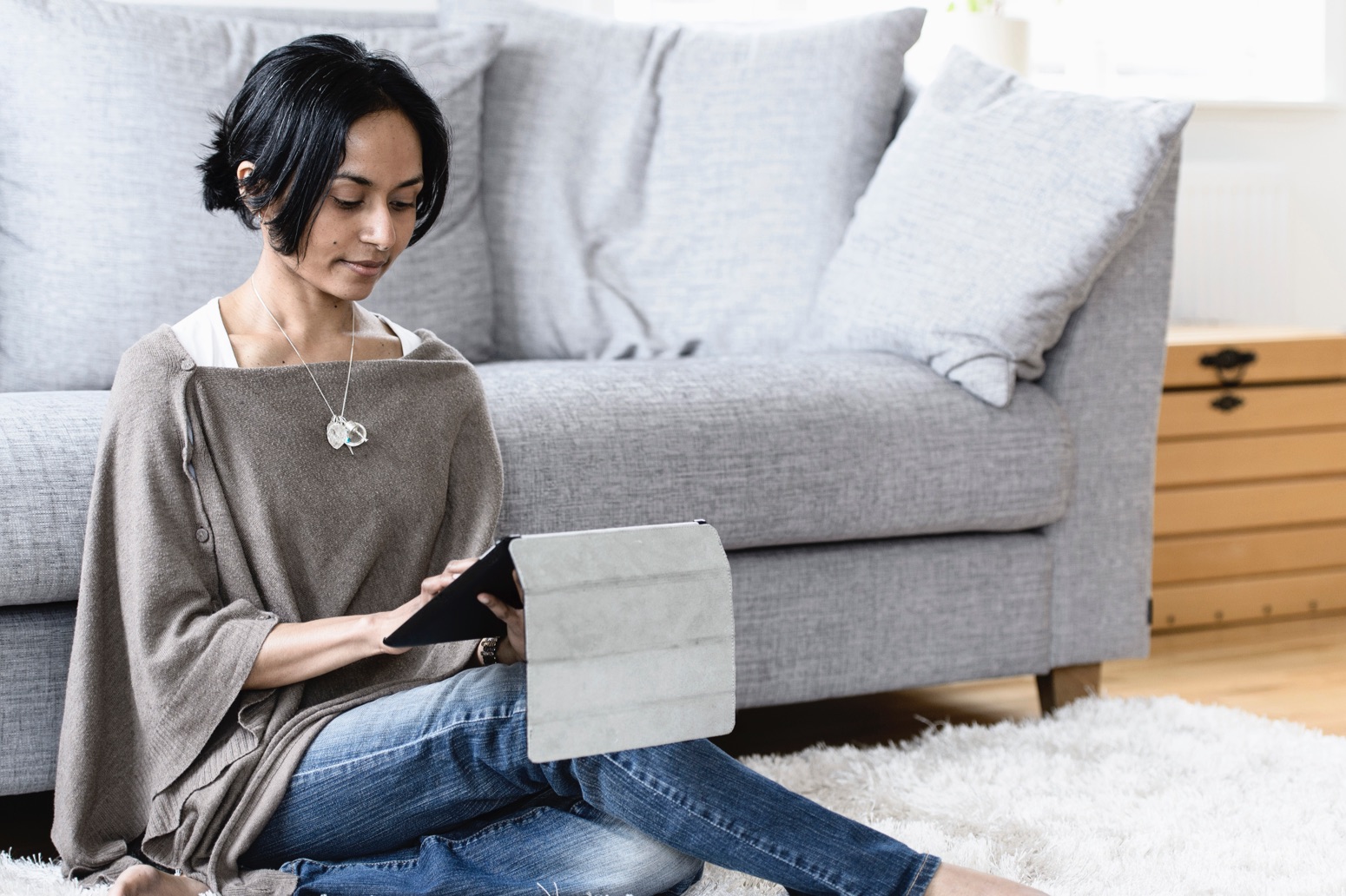 Woman using tablet at home