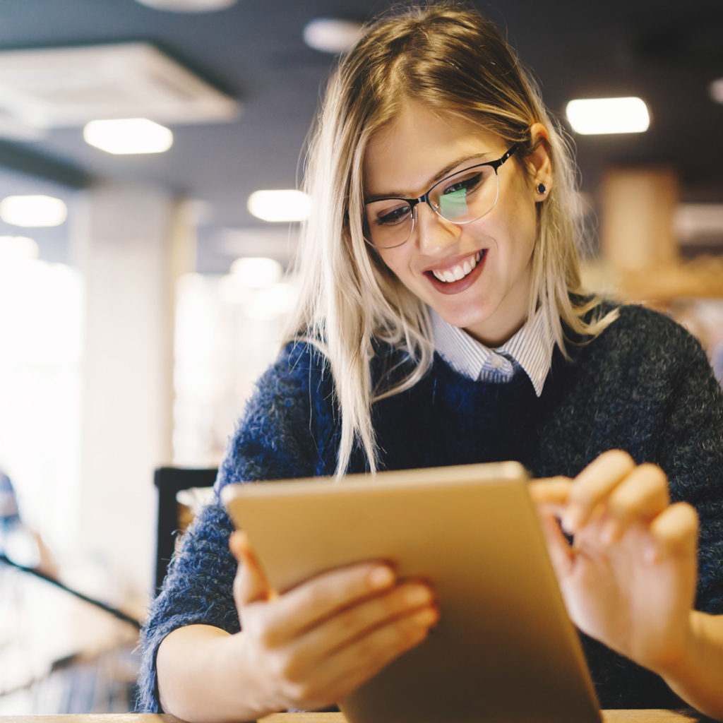 Female student on Ipad in library